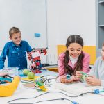 schoolkids working on robot at STEM robotics lesson